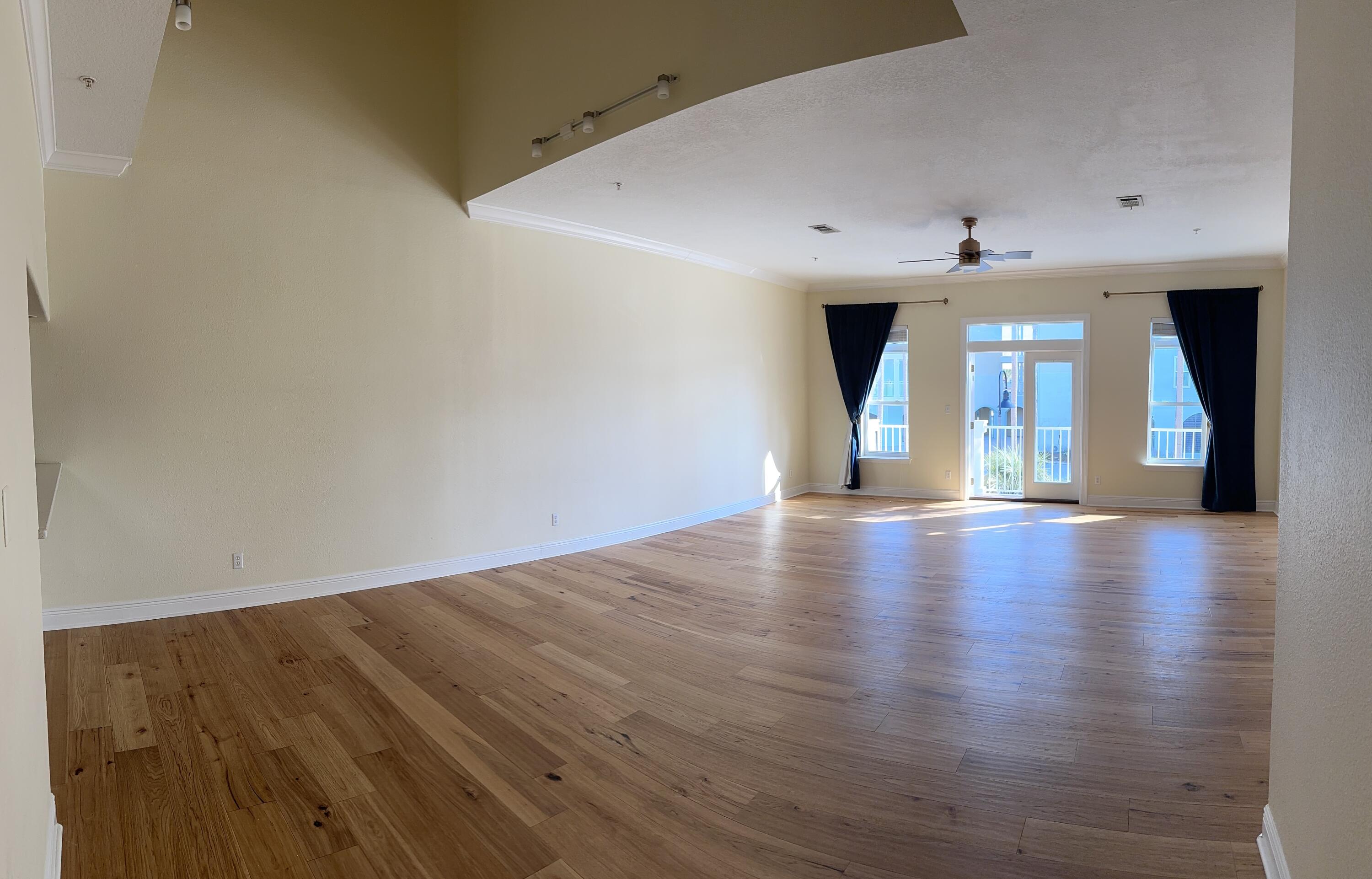 a view of a room with wooden floor
