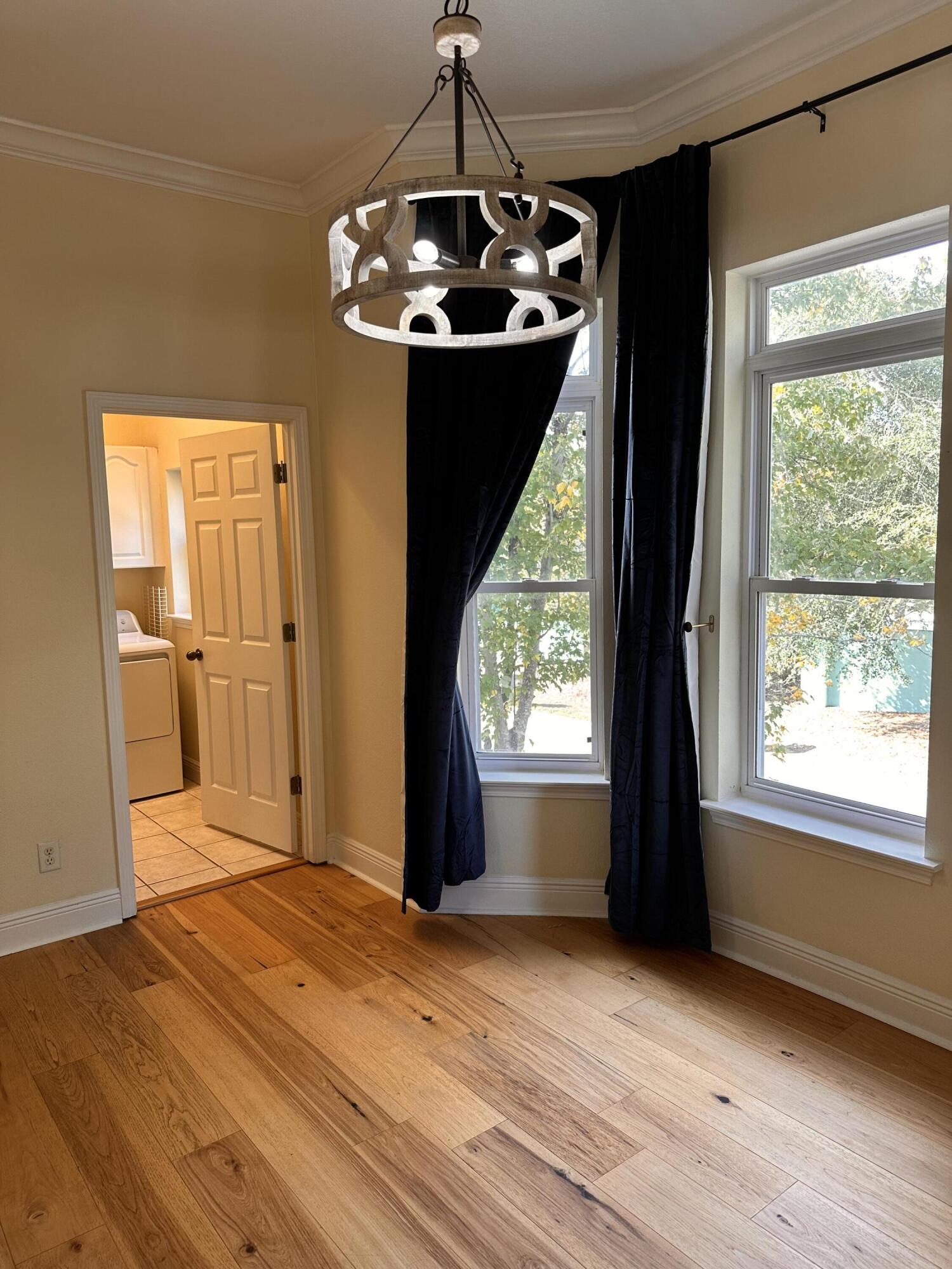 56 Spires Lane, Unit E16 Santa Rosa Beach, FL 32459 - Photo 13 of 17 a view of a livingroom with wooden floor and a chandelier