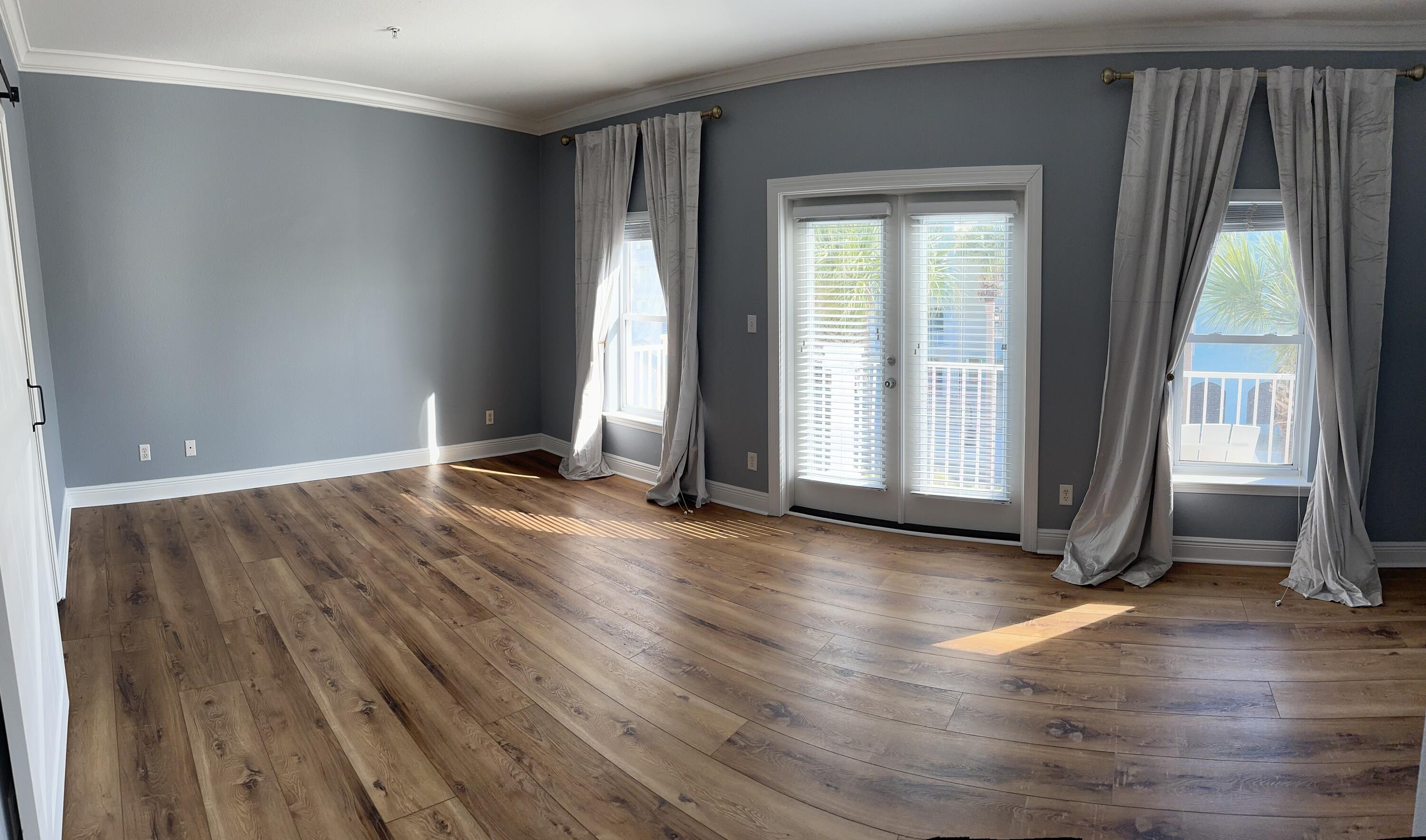 56 Spires Lane, Unit E16 Santa Rosa Beach, FL 32459 - Photo 3 of 17 an empty room with wooden floor and windows