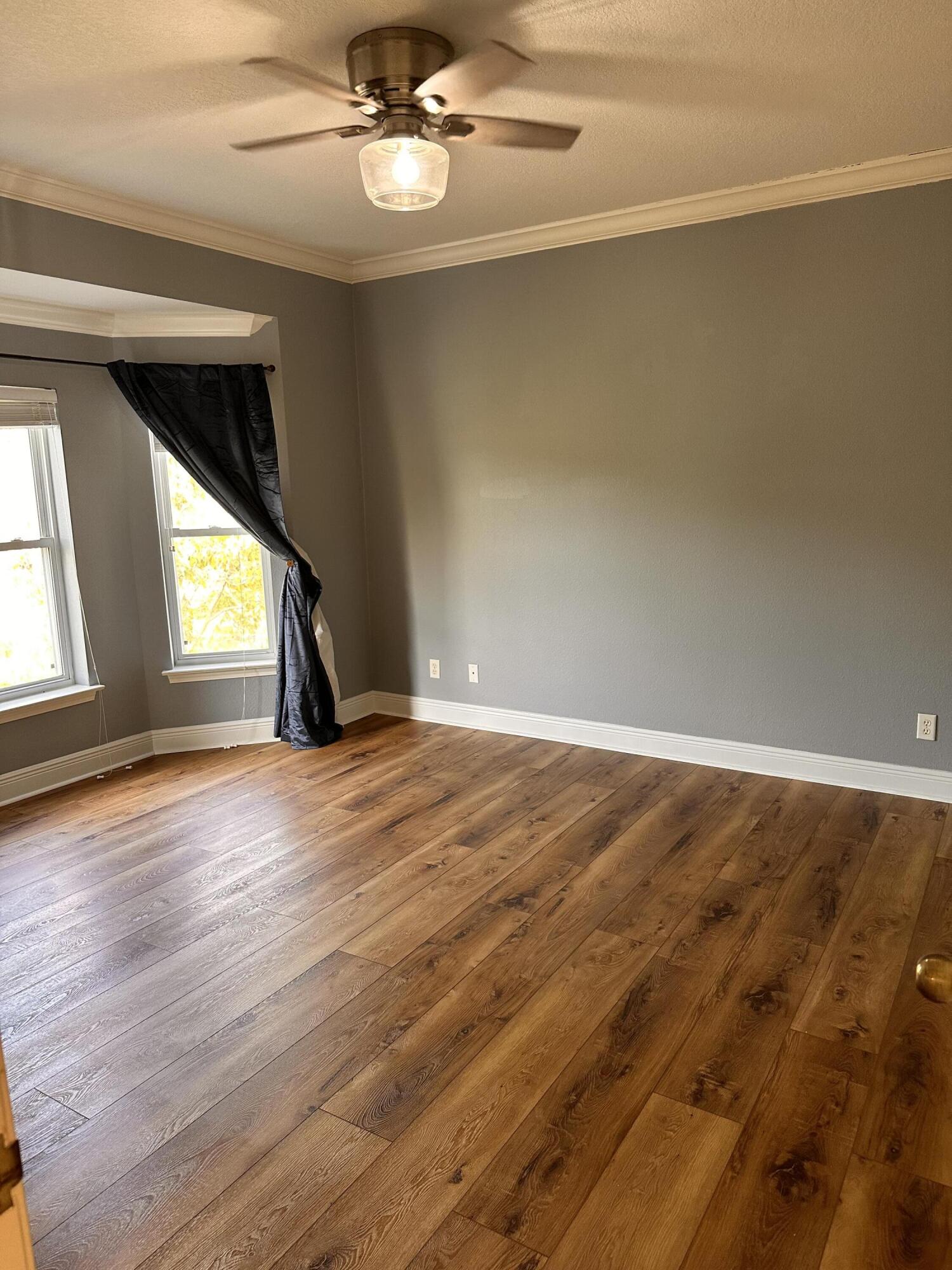 56 Spires Lane, Unit E16 Santa Rosa Beach, FL 32459 - Photo 4 of 17 an empty room with wooden floor and windows