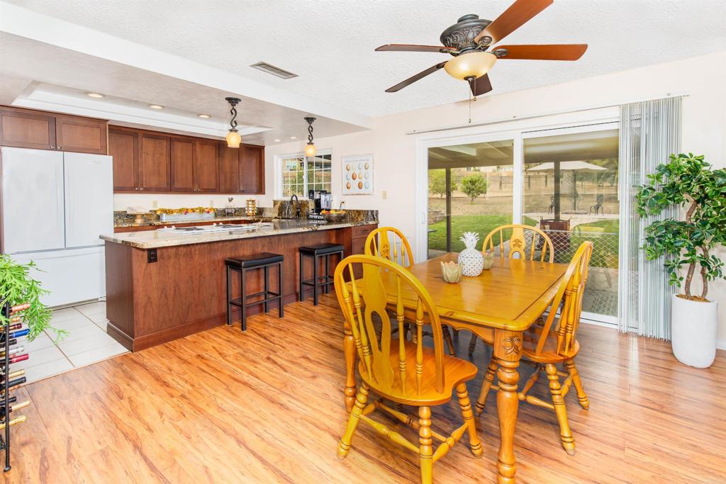 16327 Scarbery Road Ramona, CA 92065 - Photo 11 of 40 a view of a dining room with furniture window and wooden floor
