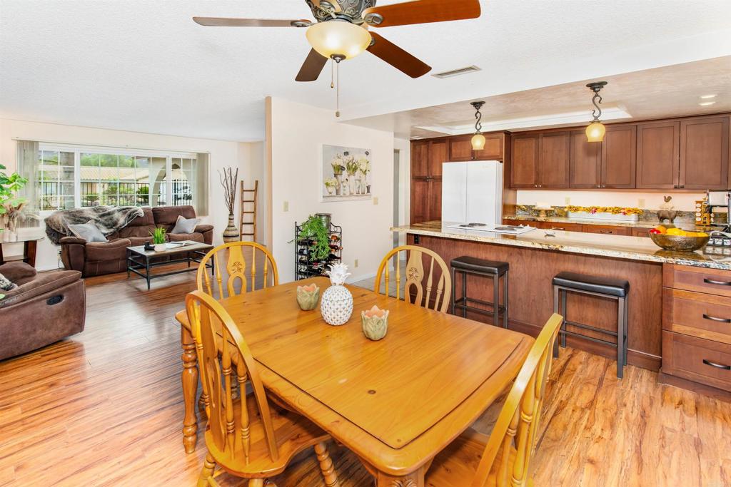 16327 Scarbery Road Ramona, CA 92065 - Photo 13 of 40 a kitchen with a table chairs and wooden floor
