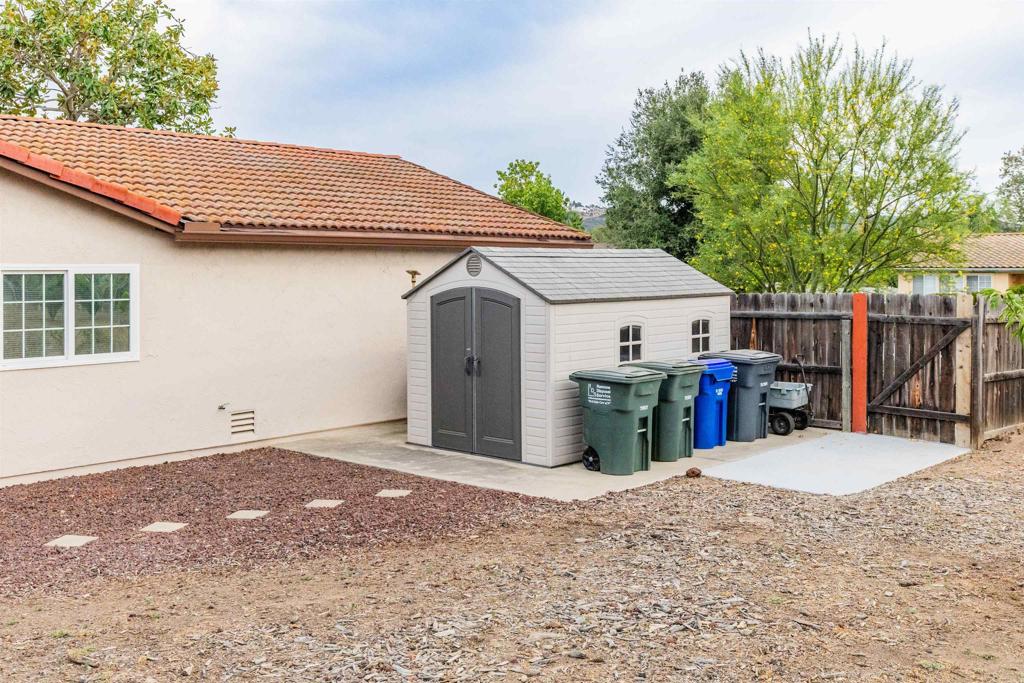 16327 Scarbery Road Ramona, CA 92065 - Photo 25 of 40 a view of a house with a patio and wooden fence