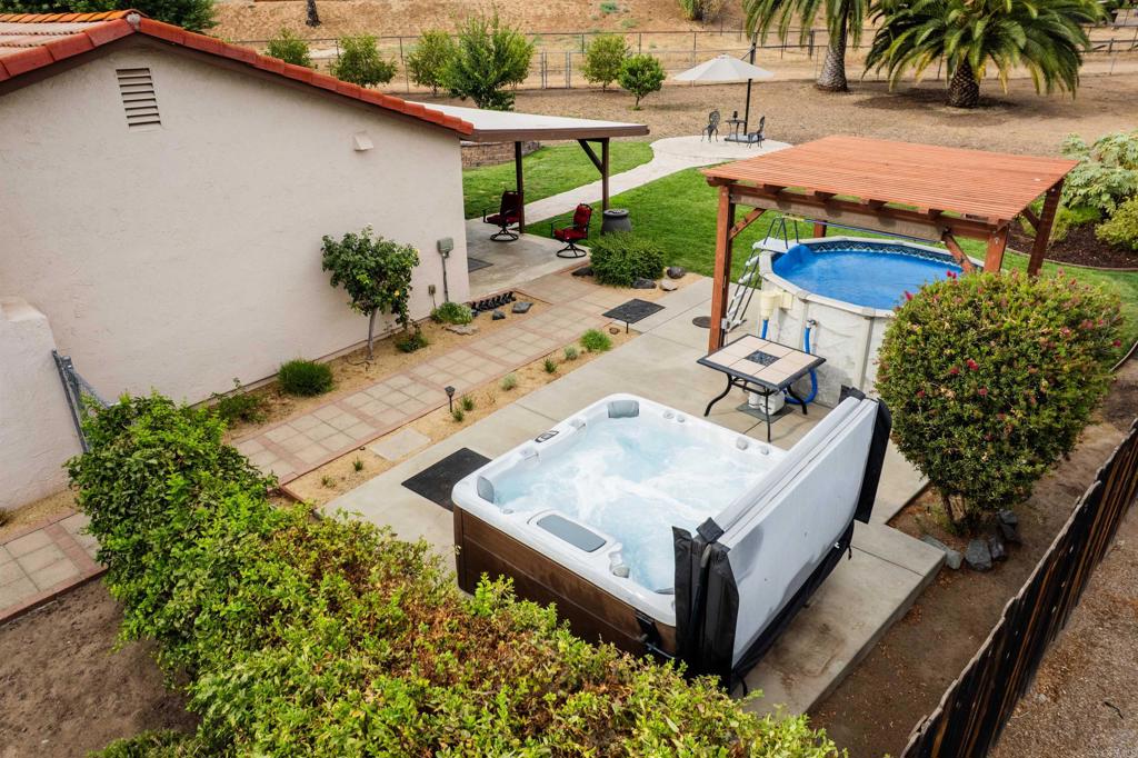 16327 Scarbery Road Ramona, CA 92065 - Photo 3 of 40 a view of a backyard with plants and patio