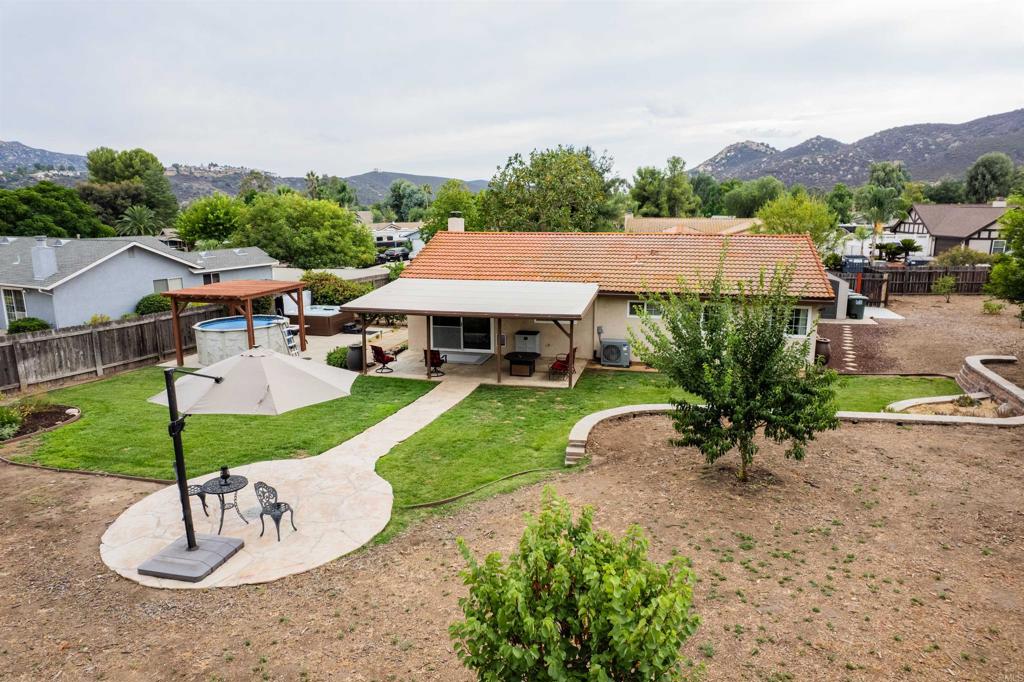 16327 Scarbery Road Ramona, CA 92065 - Photo 34 of 40 a view of a house with a garden and plants