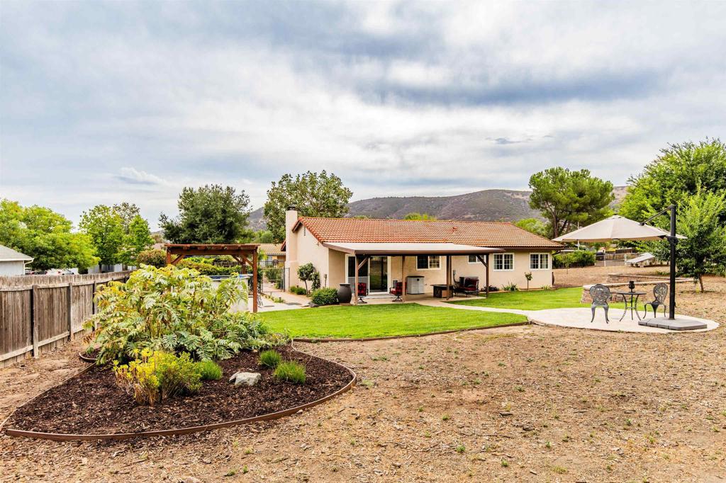 16327 Scarbery Road Ramona, CA 92065 - Photo 36 of 40 a view of a big house with a big yard and potted plants