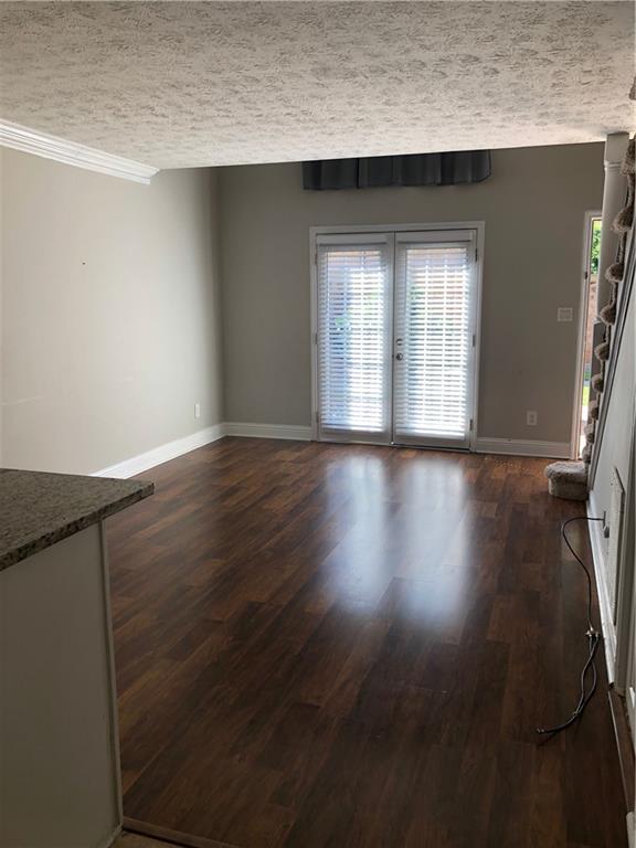 6980 Roswell Road, Unit I6 Sandy Springs, GA 30328 - Photo 1 of 1 an empty room with wooden floor and windows