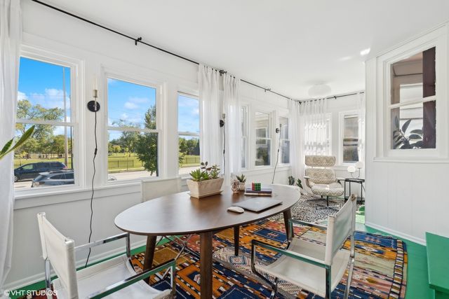 a view of a dining room with furniture and window