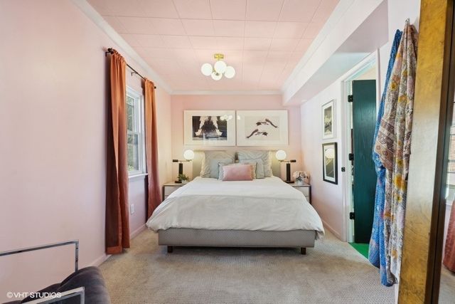 a spacious bedroom with a bed and a window