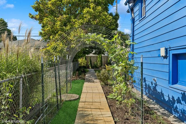 a pathway of a house with a yard