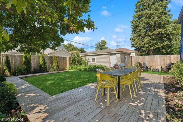 a view of a house with backyard and a sitting area