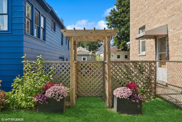 a front view of a house with a large tree
