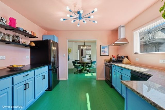 a kitchen with kitchen island a large counter top space appliances and cabinets
