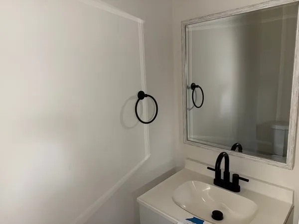 a bathroom with a sink and mirror