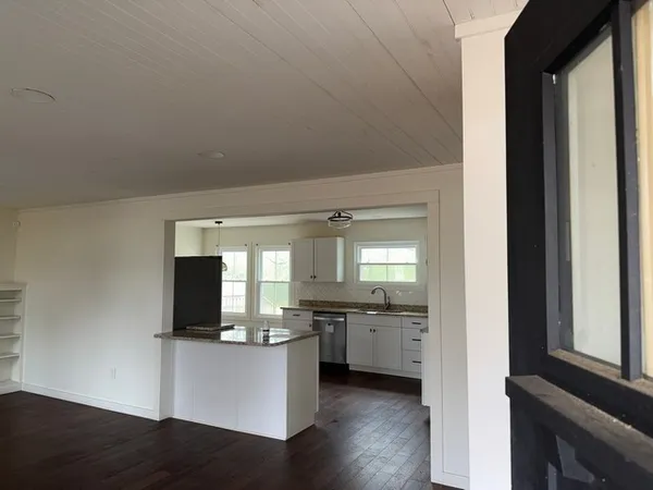 a view of kitchen with sink and window