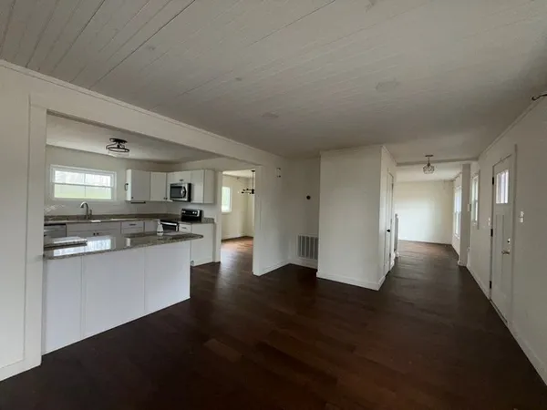 a view of a kitchen with a sink and cabinets