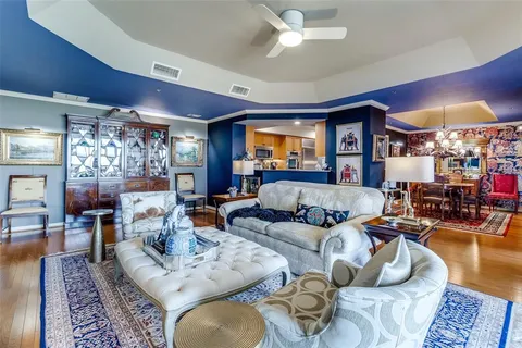 a living room with furniture and a chandelier