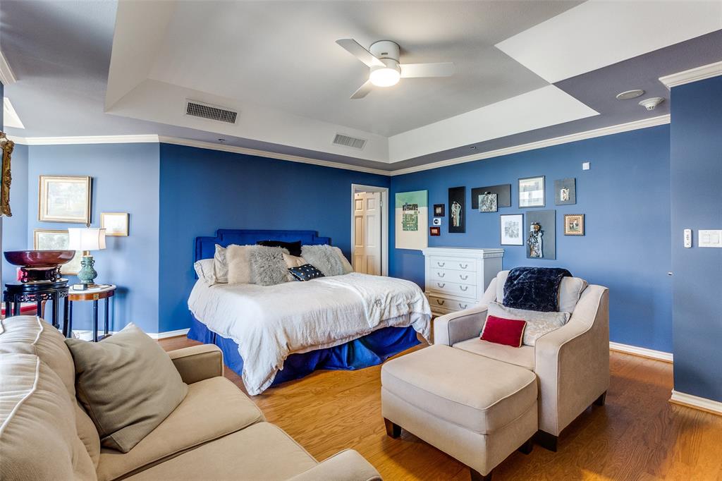 5909 Luther Lane, Unit 2104 Dallas, TX 75225 - Photo 15 of 22 a bedroom with furniture and a chandelier