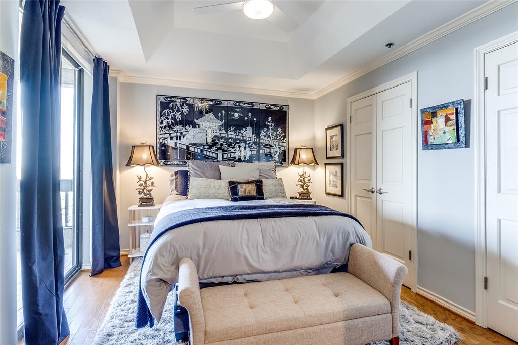5909 Luther Lane, Unit 2104 Dallas, TX 75225 - Photo 15 of 21 Bedroom with a raised ceiling, wood finished floors, ceiling fan, ornamental molding, and a closet