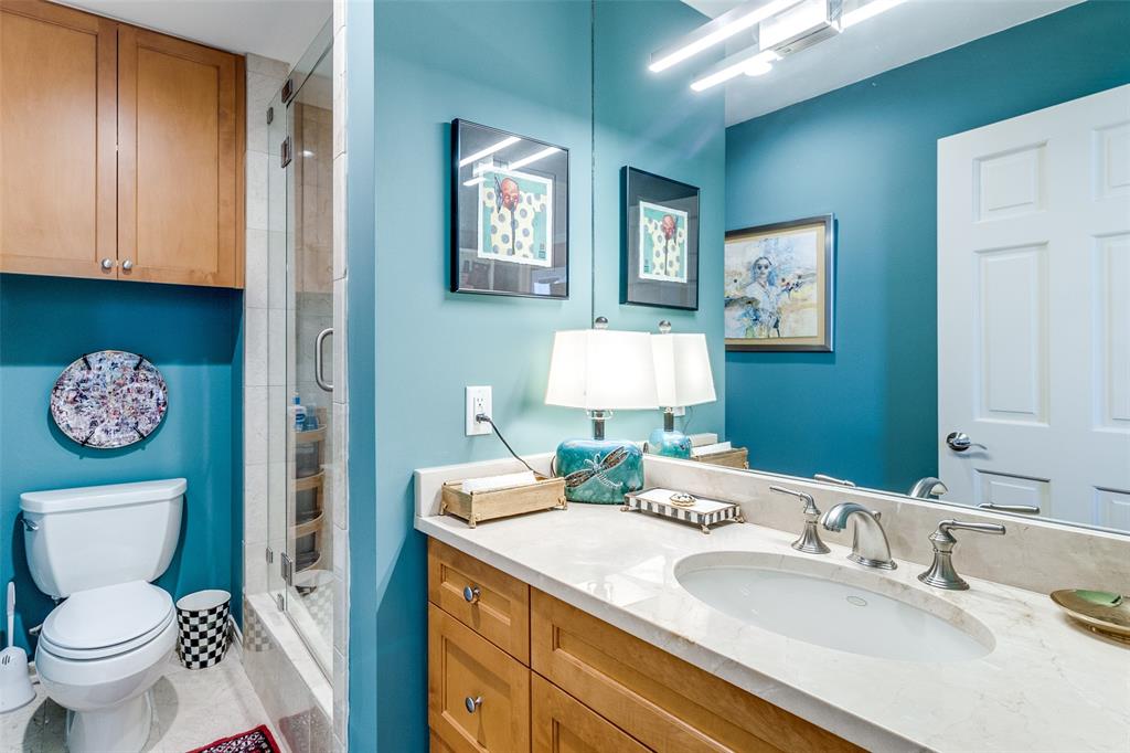 5909 Luther Lane, Unit 2104 Dallas, TX 75225 - Photo 16 of 21 Bathroom featuring a stall shower and vanity