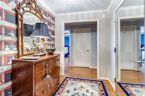 a view of walk in closet with wooden floor