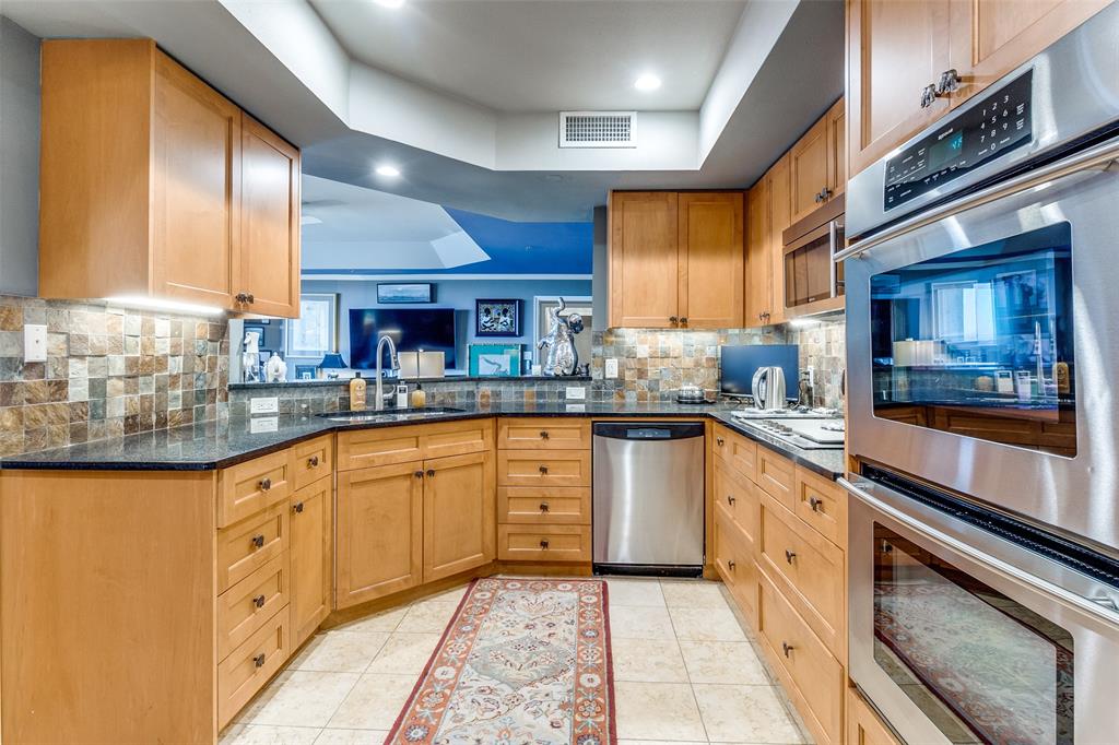 5909 Luther Lane, Unit 2104 Dallas, TX 75225 - Photo 8 of 22 a large kitchen with stainless steel appliances granite countertop a sink and cabinets