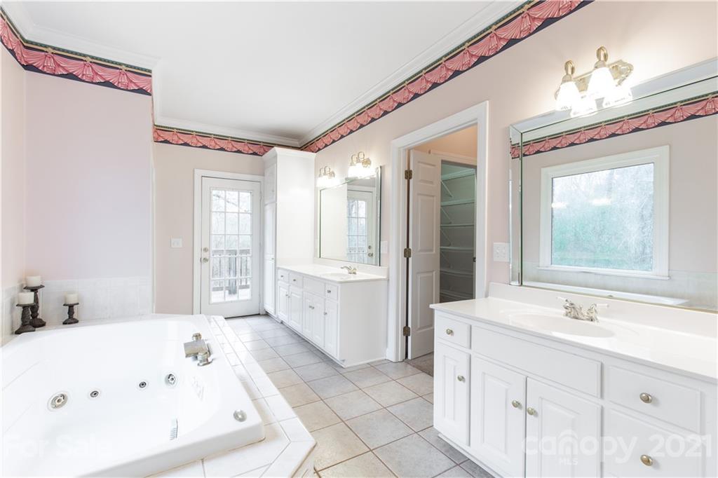 951 Porter Ranch Road Lancaster, SC 29720 - Photo 22 of 46 a bathroom with a tub sink and mirror