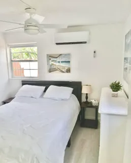 a bedroom with a bed and a painting on the wall