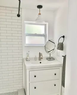 a bathroom with a sink vanity and a mirror