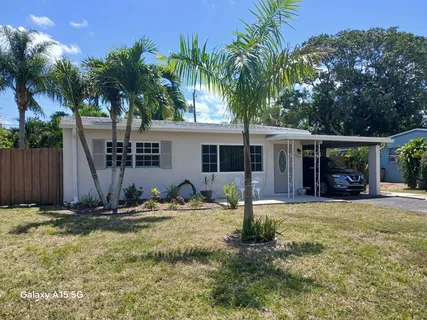a backyard of a house with garden and outdoor seating