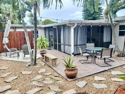 a view of outdoor sitting area with furniture and wooden fence