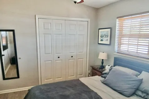 a bedroom with a bed and a window