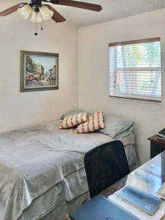 a bedroom with a bed and a window