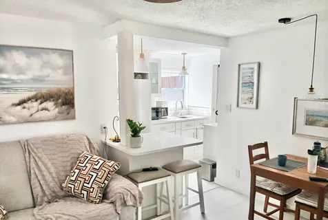 a living room with furniture and painting on the wall