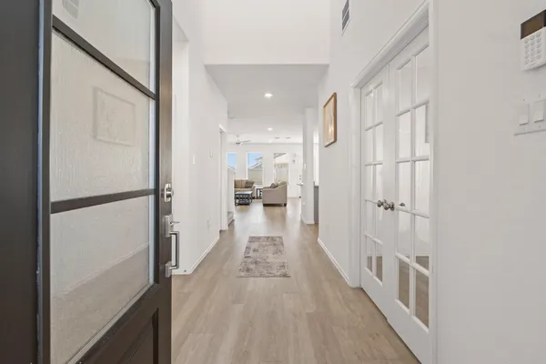 a view of a hallway with wooden floor and staircase