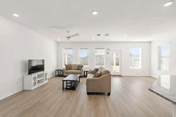 a living room with furniture and a flat screen tv