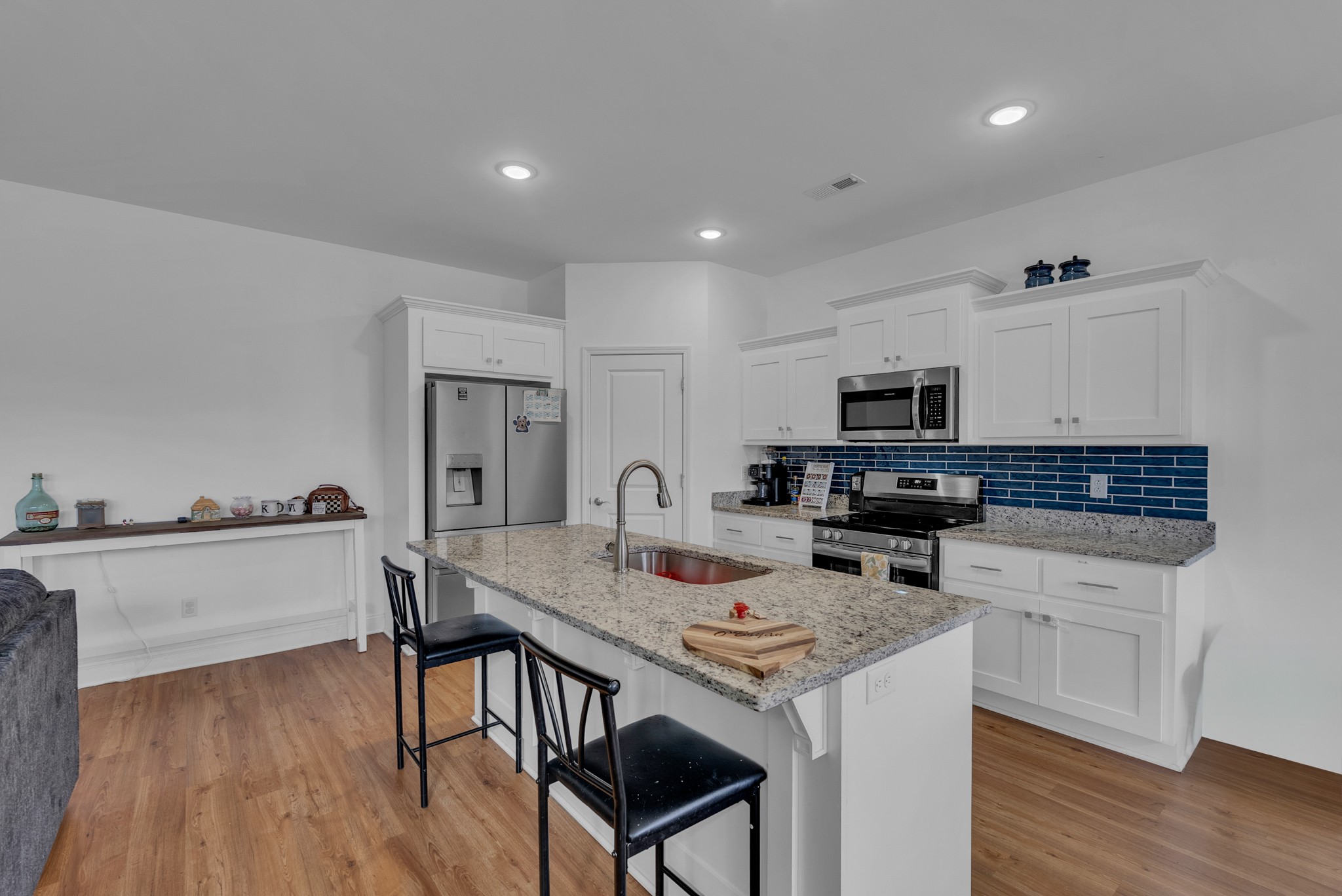 415 Old Morrison Road McMinnville, TN 37110 - Photo 3 of 20 a kitchen with stainless steel appliances a stove top oven a sink dishwasher and a refrigerator with wooden floor
