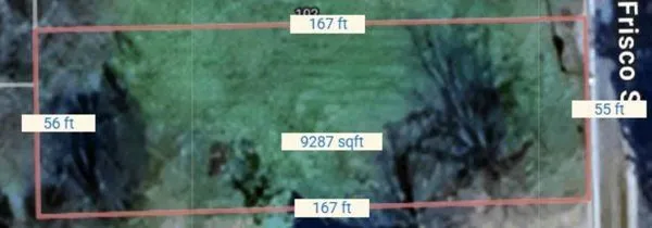 a view of a bunch of plants and a sign board