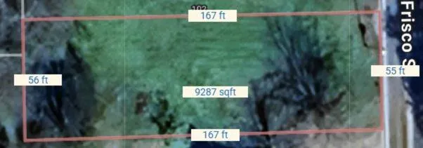 a view of a bunch of plants and a sign board