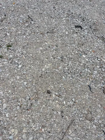 a view of garage with a car parked in it