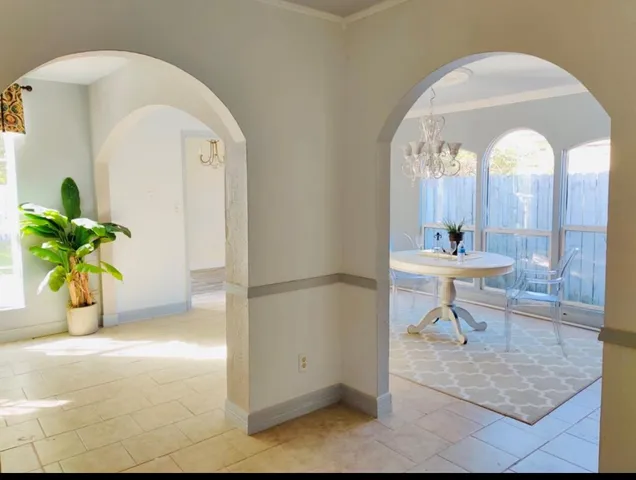 a view of living room filled with furniture and a potted plant