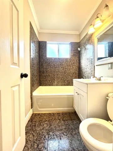 a bathroom with a sink a toilet and bathtub