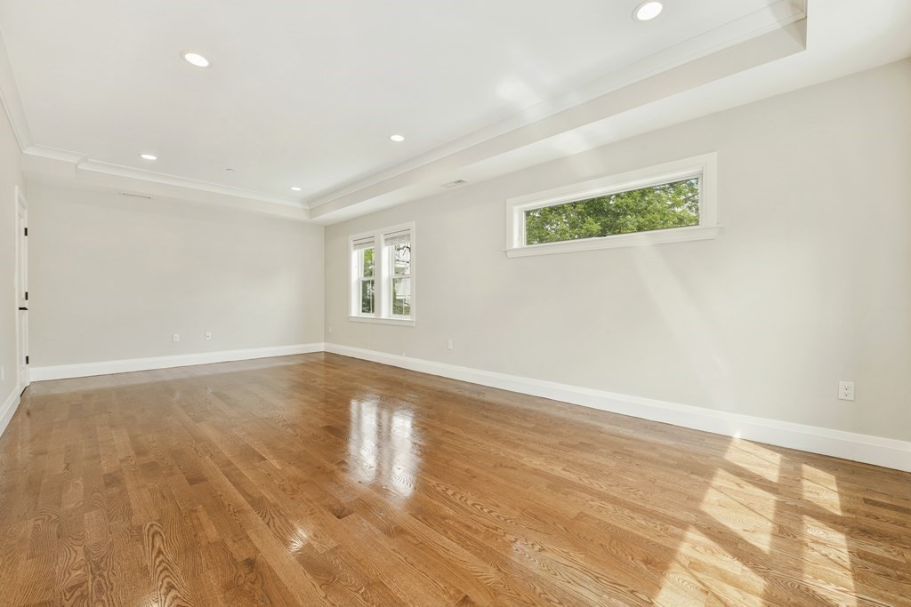 1514 R Columbia Road, Unit 2 Boston, MA 02127 - Photo 11 of 28 an empty room with wooden floor and windows