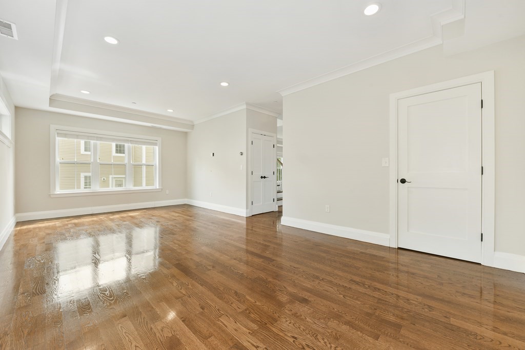1514 R Columbia Road, Unit 2 Boston, MA 02127 - Photo 12 of 28 an empty room with wooden floor and windows