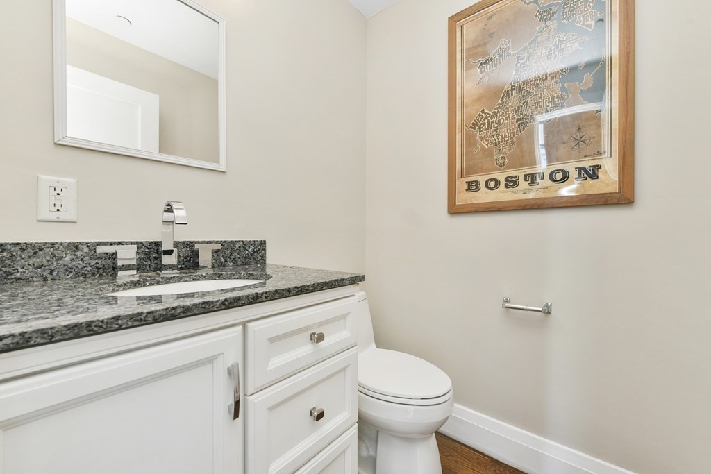 1514 R Columbia Road, Unit 2 Boston, MA 02127 - Photo 13 of 28 a bathroom with a granite countertop toilet sink and mirror