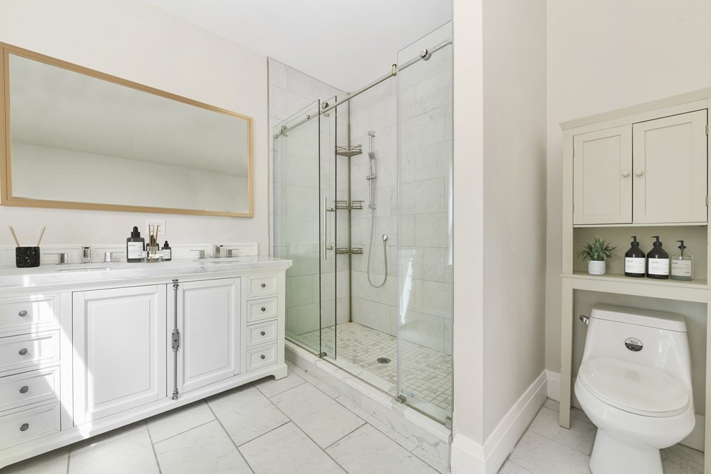 1514 R Columbia Road, Unit 2 Boston, MA 02127 - Photo 17 of 28 a spacious bathroom with a shower sink and mirror