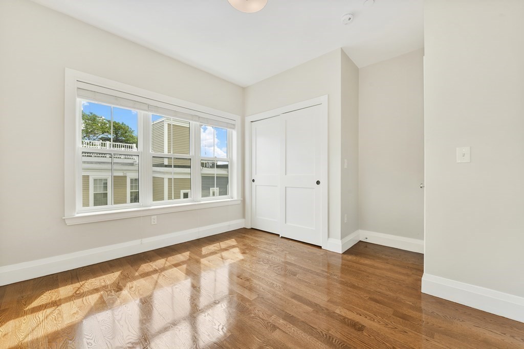 1514 R Columbia Road, Unit 2 Boston, MA 02127 - Photo 18 of 28 a view of an empty room with wooden floor and a window