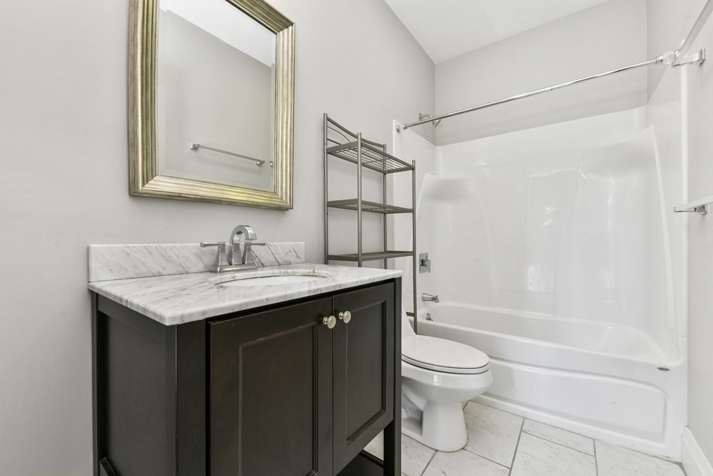 1514 R Columbia Road, Unit 2 Boston, MA 02127 - Photo 20 of 28 a bathroom with a granite countertop sink toilet and shower
