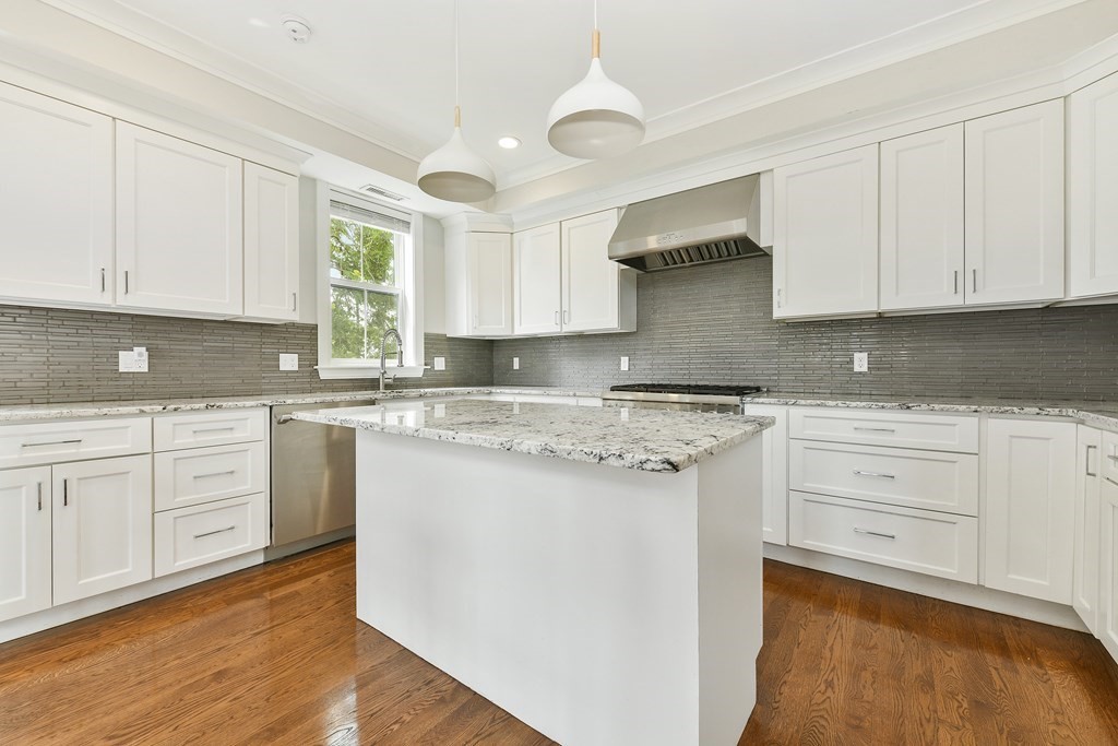 1514 R Columbia Road, Unit 2 Boston, MA 02127 - Photo 2 of 28 a kitchen with granite countertop white cabinets and white appliances