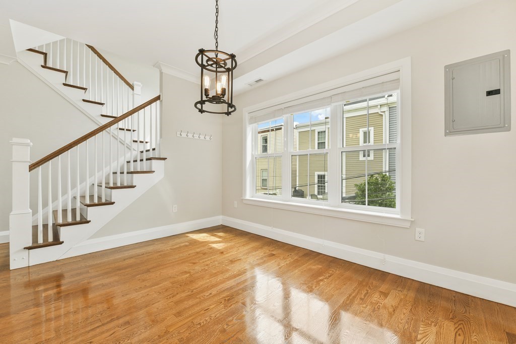 1514 R Columbia Road, Unit 2 Boston, MA 02127 - Photo 8 of 28 a view of an empty room with wooden floor and a window